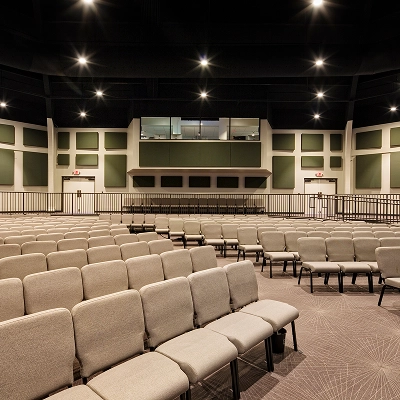 Auditorium with lots of chairs, lights, and sound proofing on the walls