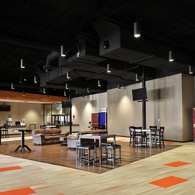 Large lobby with lounge area, tables and chairs, and a cafe