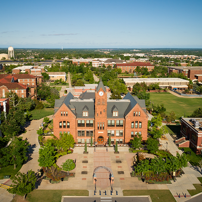 University campus with large building and surrounding campus in the background